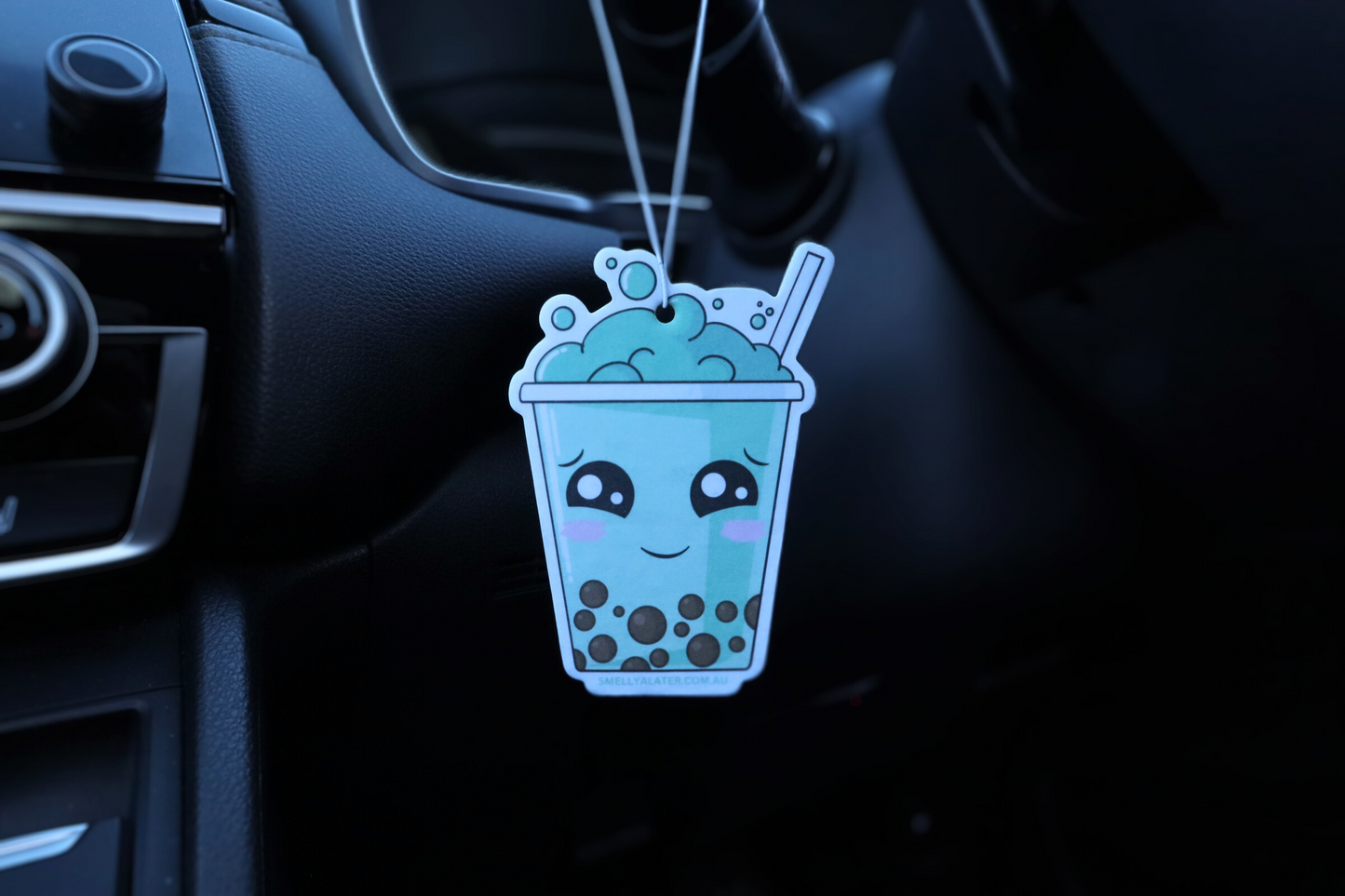 Cute shy blushing green boba/bubble tea with brown pearls, big sparkling eyes and green bubbles, hung in a cool black interior car. Smell Ya Later - Scented Air Freshener. Suitable for homes, wardrobes, cupboards, bathrooms, cars, office space, pet rooms, bed rooms, kitchen.